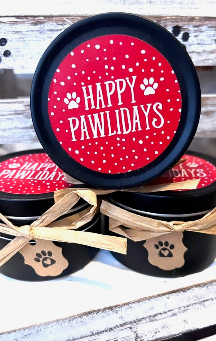 Black containers with red 'Happy Pawlidays' labels on a wooden surface