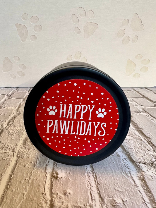 Black container with a red label reading 'Happy Pawlidays' on a surface with paw prints.