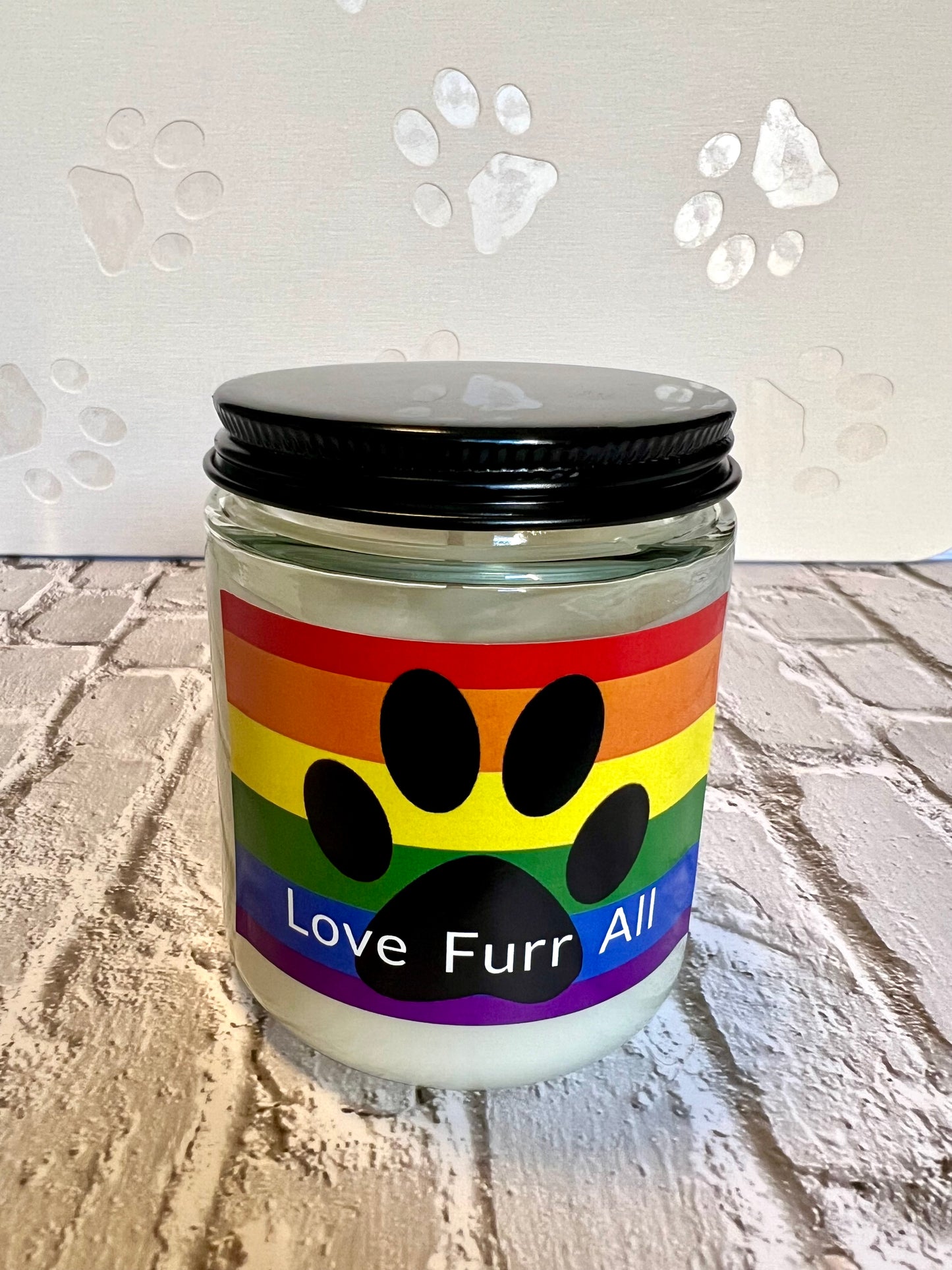 Candle jar with rainbow label featuring a paw print and 'Love Furr All' text 
