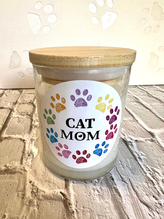 Candle with a 'Cat Mom' label featuring colorful paw prints 