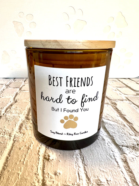 Candle with a label reading 'Best friends are hard to find, but I found you' on a wooden surface.